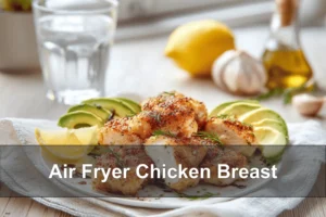 Air Fryer Chicken Breast - Perfectly Juicy Every Time Air Fryer Chicken Breast sliced on plate with avocado lemon wedges and balsamic drizzle