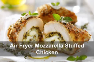 Air Fryer Mozzarella Stuffed Chicken: Easy and Delicious Recipe Air Fryer Mozzarella Stuffed Chicken plated on white cloth with pesto and basil sprigs