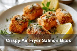 Crispy Air Fryer Salmon Bites on white napkin with lemon and fresh herbs