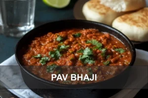 PAV BHAJI hero image with buttered pav buns and vibrant bhaji in a rustic kadhai
